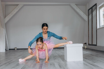 Baby ballet studio. Little ballerina with a coach in dance class. Ballet trainer for children