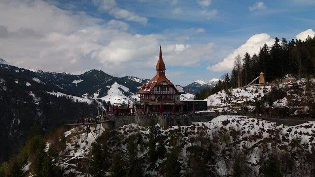Harder Kulm Interlaken Switzerland snowy alps drone aerial orbit cloudy day