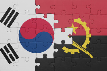 puzzle with the colourful national flag of angola and flag of south korea.