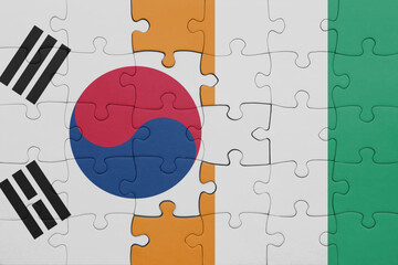 puzzle with the colourful national flag of cote divoire and flag of south korea.