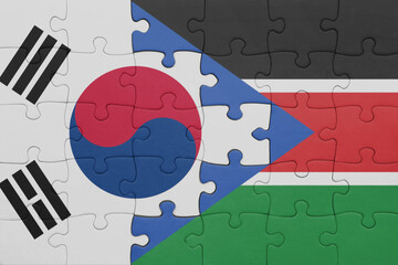 puzzle with the colourful national flag of south sudan and flag of south korea.