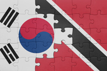 puzzle with the colourful national flag of trinidad and tobago and flag of south korea.