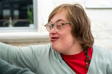 Expressive portrait of a 41 yo woman with the Down Syndrome, Tienen, Flanders, Belgium