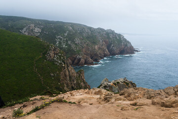 Coastline of Portugal, Cabo da Roca. Cape Roca in Sintra. The lighthouse in Cabo da Roca. Cliffs and rocks on the Atlantic ocean coast. Cloud day