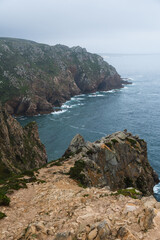 Coastline of Portugal, Cabo da Roca. Cape Roca in Sintra. The lighthouse in Cabo da Roca. Cliffs and rocks on the Atlantic ocean coast. Cloud day