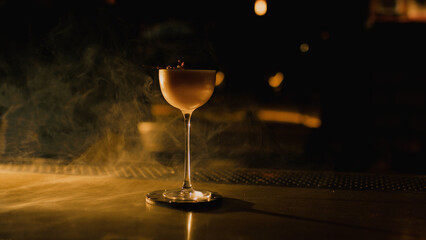 Elegant cocktail on bar with smoke