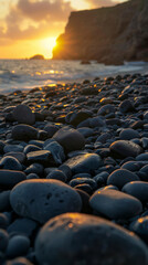 Obraz premium Sunset over rocky beach with wet pebbles