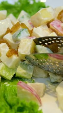 picking up potato salad buffet in a restaurant Olivier russian salad -a classic recipe with mayonnaise, an incredible taste, homemade recipe.