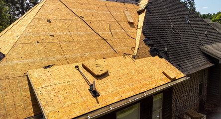 House with new roof being installed © Chad Robertson