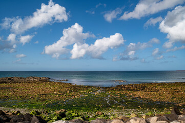 The french Channel shoreline on the Normandy coast. Close to Le Becquet marina, the blue of the water and the warm hues of the shoreline.