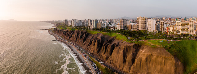 LIMA, PERU: Aerial view of Miraflores town, cliff and the Costa Verde high way