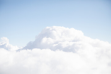 Sunrise above textured clouds from airplane window