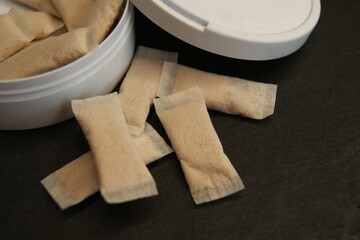 Packaging and nicotine pads on a dark background. 