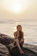 Portrait with a summer mood. Relaxation on the ocean shore, vacation. Girl in swimsuit