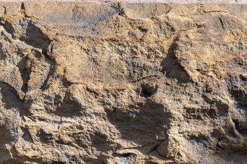 Stony texture of gray cracked wall
