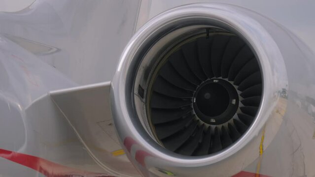 Close up view of an airplane turbine, jet engine rotating. Transportation, journey, technology and tourism concept
