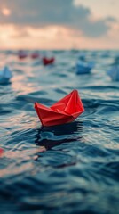 Red Paper Boat Floating on Calm Water in Daytime