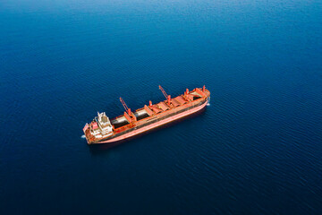 Dry bulk cargo carrier ship anchored washing ship holds preparing for loading new dry cargo, aerial view © Leonid