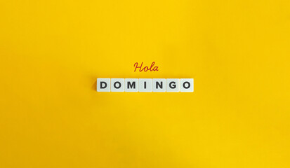 Hola Domingo (Hello Sunday) in Spanish Language. Text on Block Letter Tiles on Yellow Background. Minimal Aesthetics. © photoopus