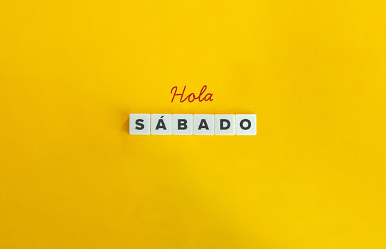 Hola S&aacute;bado. Text on Block Letter Tiles on Flat Background. Minimalist Aesthetics.