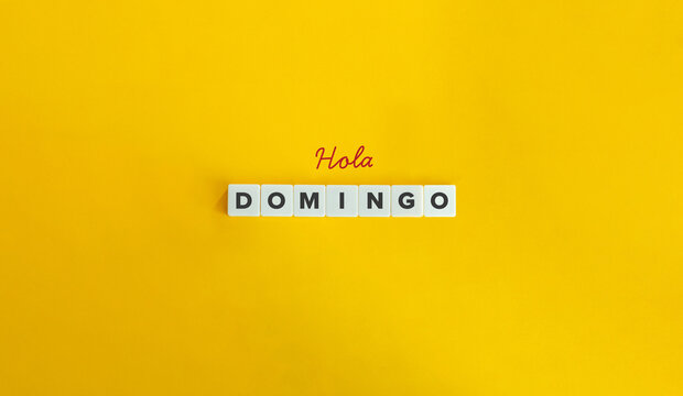 Hola Domingo (Hello Sunday) in Spanish Language. Text on Block Letter Tiles on Yellow Background. Minimal Aesthetics.