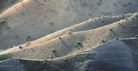 Panorama of mountain hills in the mountains of Tajikistan in the evening at sunset, natural landscape for background