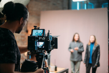 Director of photography with a camera in his hands on the set.  Filming process indoors, studio