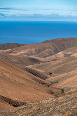 Panoramic view on colourful remote basal hills and mountains of Massif of Betancuria as seen from observation point, Fuerteventura, Canary islands, Spain
