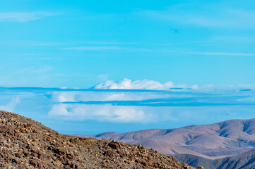 Panoramic view on colourful remote basal hills and mountains of Massif of Betancuria as seen from observation point, Fuerteventura, Canary islands, Spain