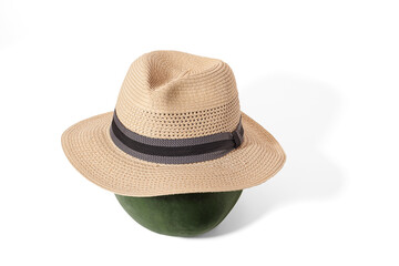 Watermelon with straw hat on white background