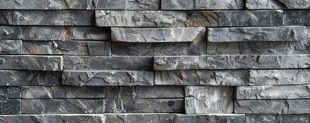 Naklejka premium textured gray brick wall highlighting architectural patterns.