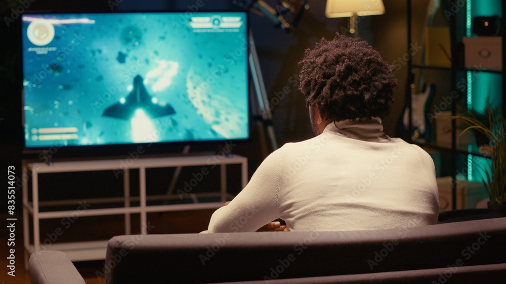 Poster gamer plays multiplayer game with spaceship shooting laser streams using crosshair overlay to hit ta