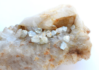 Raw natural topaz crystals on quartz rock
