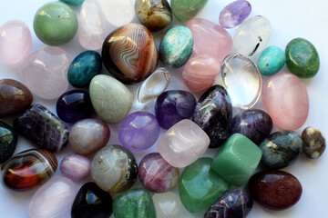 Beautiful natural semi-precious stones lie on a white background. Predictions, witchcraft,...