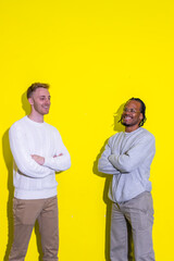 Two men standing in front of a yellow wall