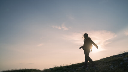 Young woman hiker walking and looking at beautiful nature view