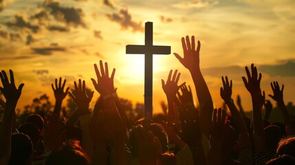 Christian worshipers raising hands up in the air in front of the cross.