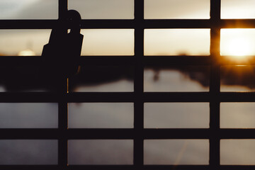 Close up of a padlock hanging on a fence