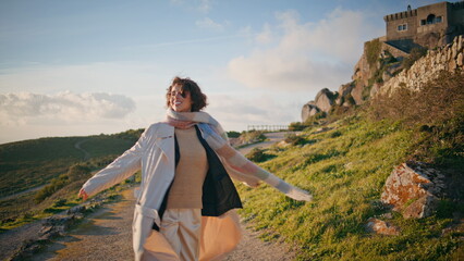Fototapeta premium Joyful tourist exploring nature landscape feeling freedom at scenic backdrop. 
