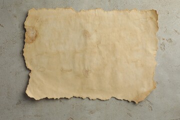 Sheet of old parchment paper on grey table, top view