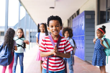In school, group of young students are standing in hallway outdoors