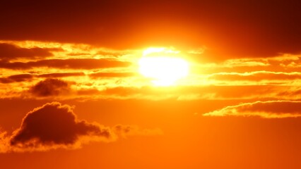 Big bright yellow hot sun disk moves down as sunset. Epic sky and sky line. Amazing orange red...