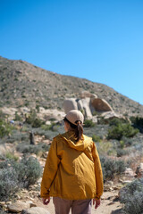 woman hiking outdoors in summer nature, walking in California national park.