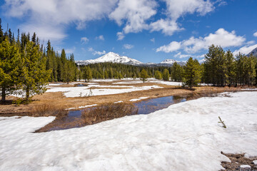 Scenic view of a snow-capped mountain and a stream under the snow. Central Oregon, Sisters, Cascade Lakes area
