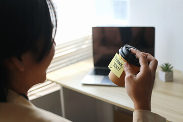 Businessman Smiling While Receiving Coffee Cup From Friends In The Office.