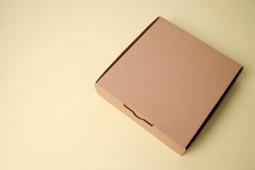 Blank Carboard Box On The Floor For Mockup Over Yellow Background