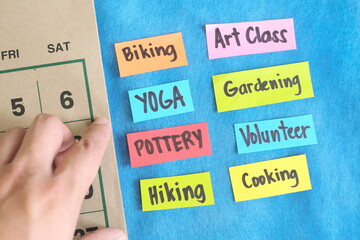 Choosing weekend health, wellness and recreational activity options concept. Paper notes on a...