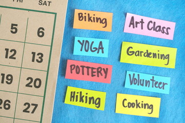 Choosing weekend health, wellness and recreational activity concept. Paper notes on a calendar.