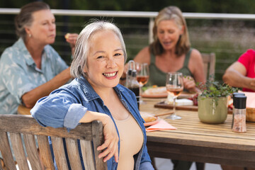 Diverse senior female friends sharing meal outdoors