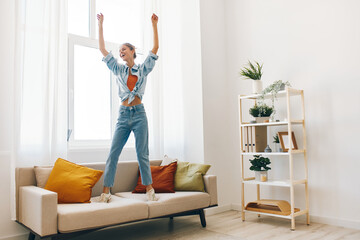 Playful Woman Jumping with Joy in Home Lifestyle